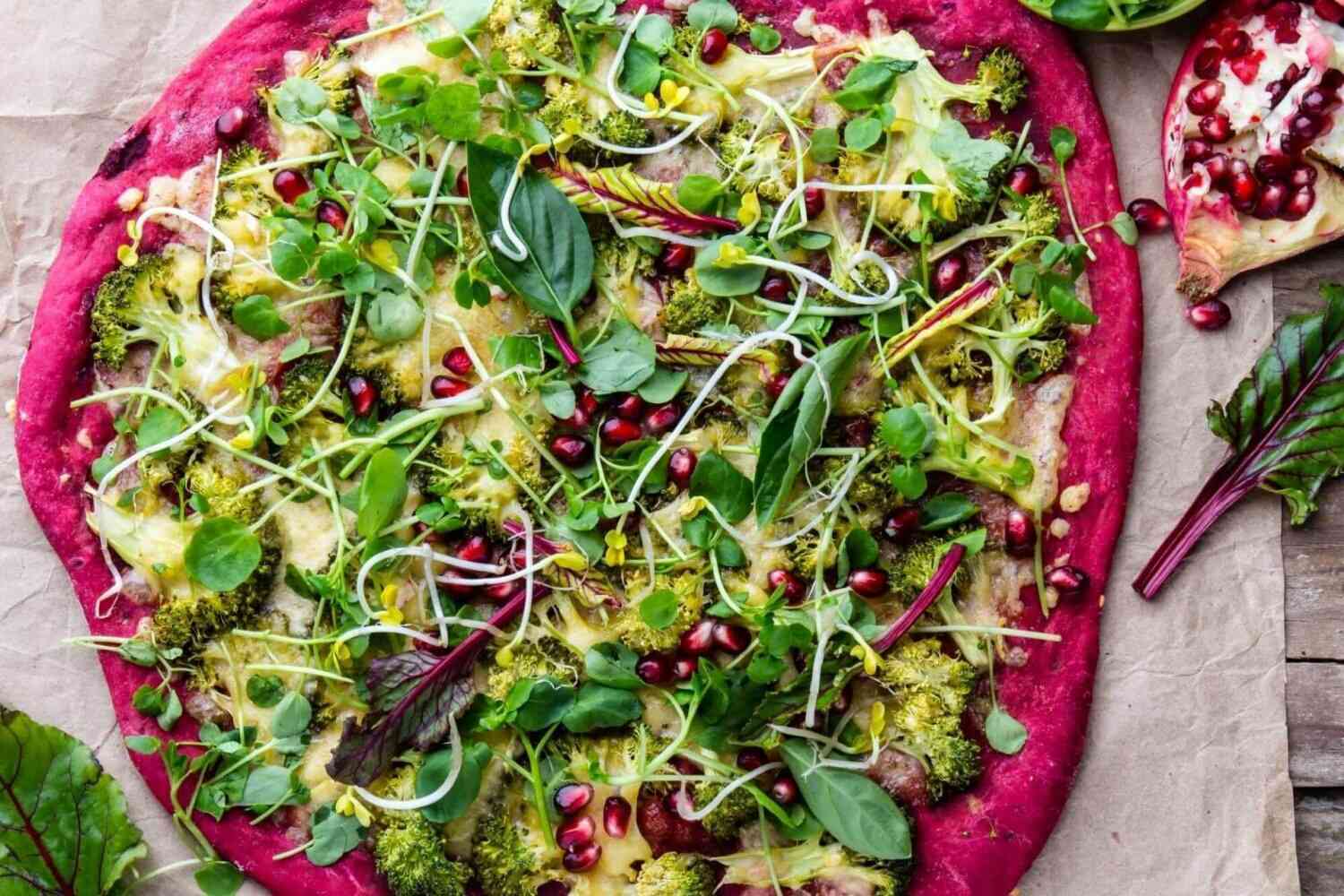 Purple beetroot dough, vegetables and sprouis pizza, Healthy fast food on slate